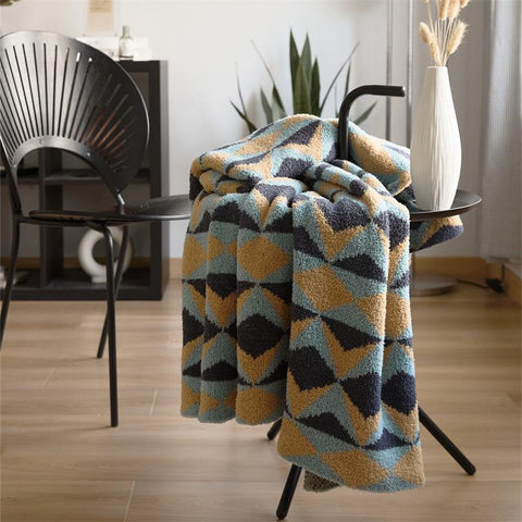 Folded geometric knit velvet throw blankets on chair – premium sofa décor