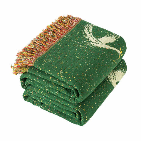 Folded green swan-pattern cotton gauze blanket with tassel edges