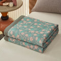 Folded vine print quilt showing compact storage design