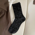 Full black leopard sock flat lay