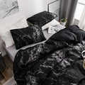 Full black marble duvet set on bed with pillows and white nightstand
