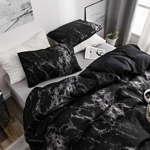 Full black marble duvet set on bed with pillows and white nightstand