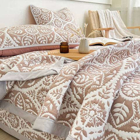 Close up detail of geometric leaf pattern on quilt bedding set showing texture and design