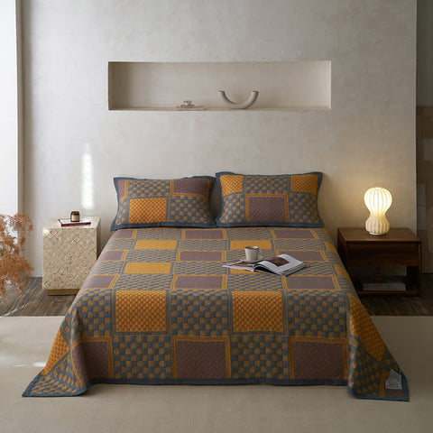 Geometric quilt set with vintage square patterns in a cozy bedroom