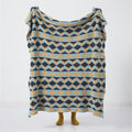 Geometric velvet knit throw blanket held open – modern patterned home throw