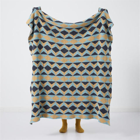 Geometric velvet knit throw blanket held open – modern patterned home throw