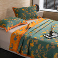 Layered look of Ginkgo Dreams botanical quilt styled with accessories