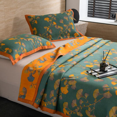 Layered look of Ginkgo Dreams botanical quilt styled with accessories