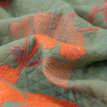 Close-up view of Ginkgo Leaf Orange Floral Blanket fabric showcasing detailed orange leaf embroidery.