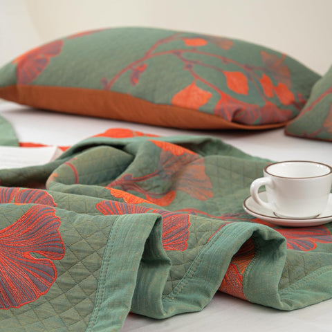 Close-up of Ginkgo Leaf Orange Floral Blanket pillowcases and blanket edges, highlighting texture and embroidery.