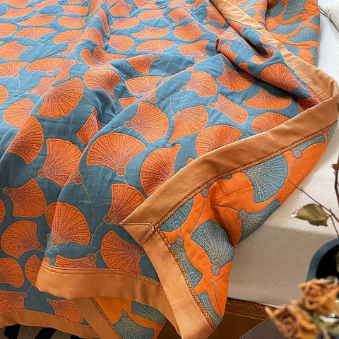 Folded ginkgo pattern quilt showing softness and layering