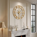 Gold decorative wall clock above white marble fireplace in luxury living room

