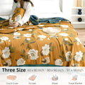 Floral patterned blanket on a bed with size options displayed.