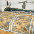 Golden Romance Boho cotton throw blanket draped on bed displaying both sides and cozy bedroom setting.