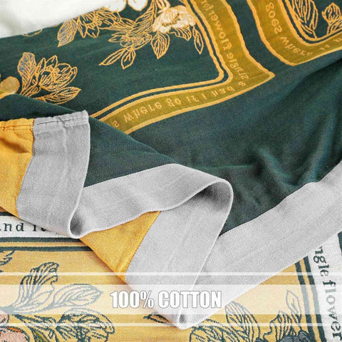 Close-up of a green and yellow fabric with floral patterns and '100% Cotton' 
Golden Romance Boho cotton throw text. Golden Romance Boho cotton throw blanket shoing edges