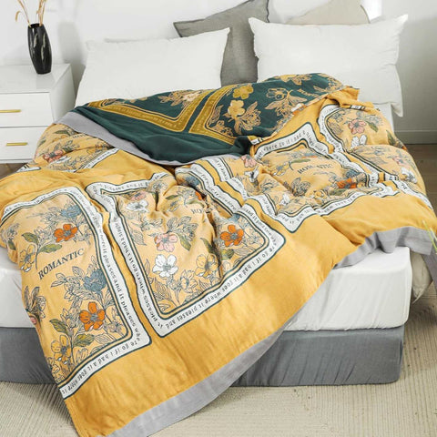 Front view of Golden Romance Boho cotton throw blanket displayed on bed showing both sides and overall design.
