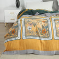 Close-up of Golden Romance Boho cotton throw blanket draped over bed, showing floral and text design with soft cotton texture.