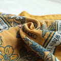 Close-up of a golden romance boho throw blanket patterned fabric with text and design