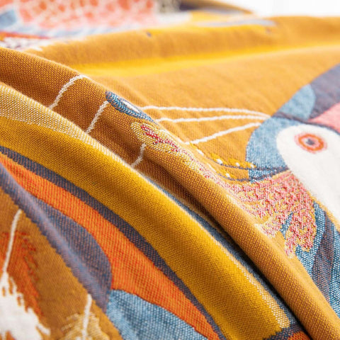 Close-up of a fabric with colorful embroidery and patterns.