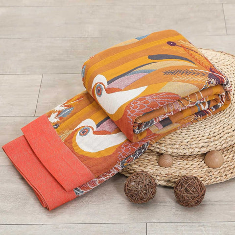 Decorative quilt with bird pattern on a woven basket