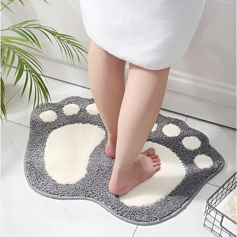 Woman stepping on gray footprint bath mat in modern bathroom setting