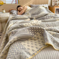 Woman sleeping under gray patchwork jacquard summer quilt
