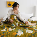 Botanical green summer quilt styled on white bed