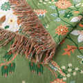 Bed styled with green reversible floral blanket