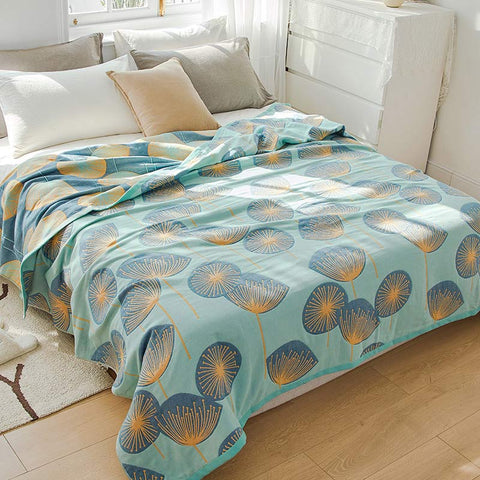 Green dandelion reversible quilt neatly laid out – soft and airy cotton fabric