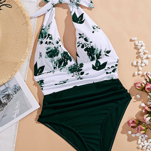 Flat lay of green floral deep V one-piece swimsuit with halter neck and ruched waist