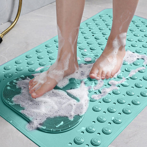 Feet scrubbing on green non-slip mat with soap suds

