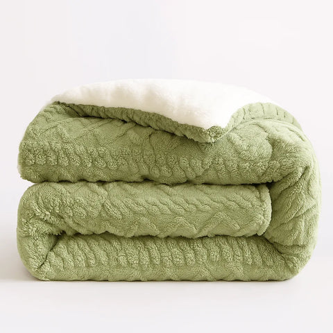 Folded green textured blanket on a white background