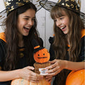 Girl holding handmade crochet Halloween pumpkin potted plant ornament