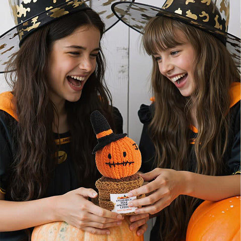 Girl holding handmade crochet Halloween pumpkin potted plant ornament