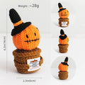 Crocheted pumpkin character with a witch hat and dimensions on a white background