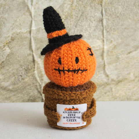 Handmade crochet Halloween pumpkin ornament with witch hat in potted plant design
