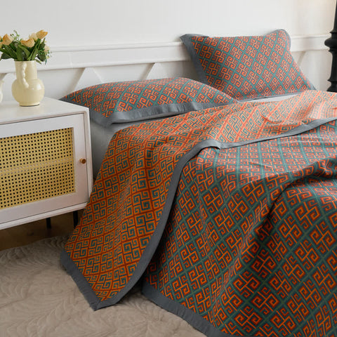 Japanese style cotton quilt on full bed with matching pillows, geometric pattern