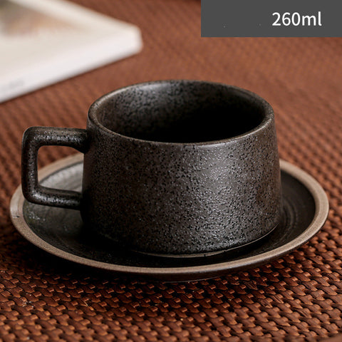 Black ceramic cup and saucer set on a textured surface with '260ml' label.