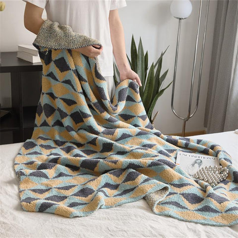 Person holding geometric velvet knit throw blanket – modern home décor accent