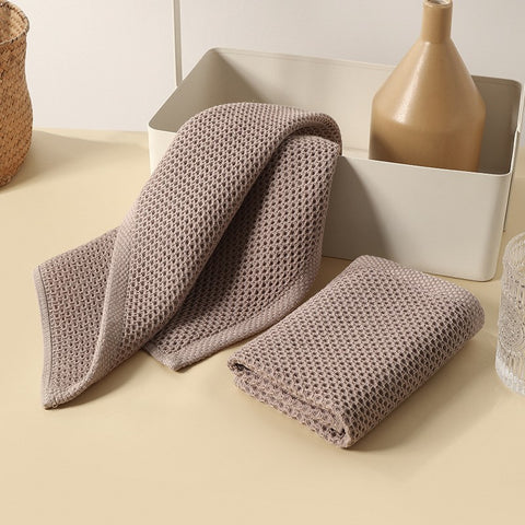 Two honeycomb towels laid on modern decor background