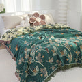 Hummingbird nature-inspired cotton throw blanket in green, reversible with beige, styled as a cozy bed cover.