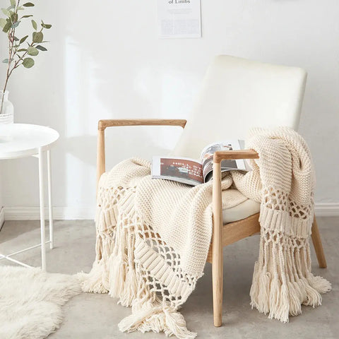 Ivory Cream Handmade Nordic Knit Tassel Blanket on wooden chair – minimalist home décor