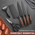 Set of kitchen knives with wooden handles on a gray surface, accompanied by a peeler and scissors.