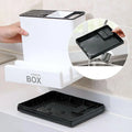 Storage box with a black tray on a kitchen counter, showing a close-up of the tray being rinsed.