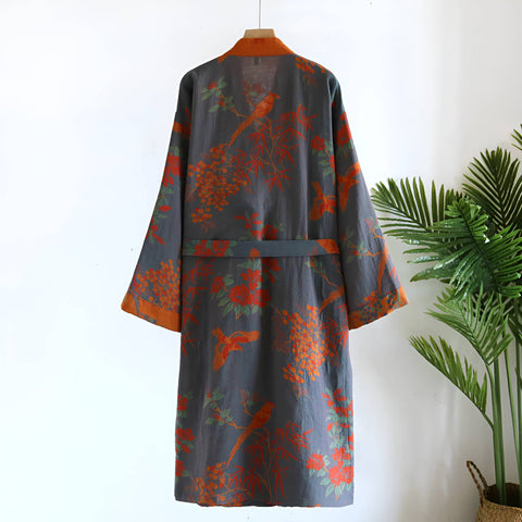 Floral patterned robe on a mannequin against a white background with a plant to the side.