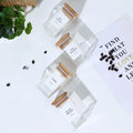 Spice jar set with printed labels shown on wood risers for a clean, styled kitchen look.

