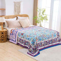 Lavender Meadow Cotton Blanket on cozy bed with beige pillows and natural boho decor