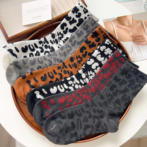 6 Leopard Print Sock Variants Displayed on Round Tray