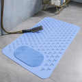 Blue bath mat with textured surface on a bathroom floor