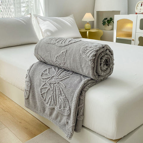 Light gray butterfly throw blanket on white bed – soft fleece couch cover